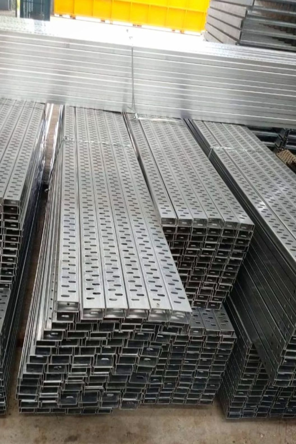 Aluminum perforated cable trays stacked in warehouse – lightweight corrosion-resistant aluminium cable management trays manufactured by Superfab Industries Pvt. Ltd.