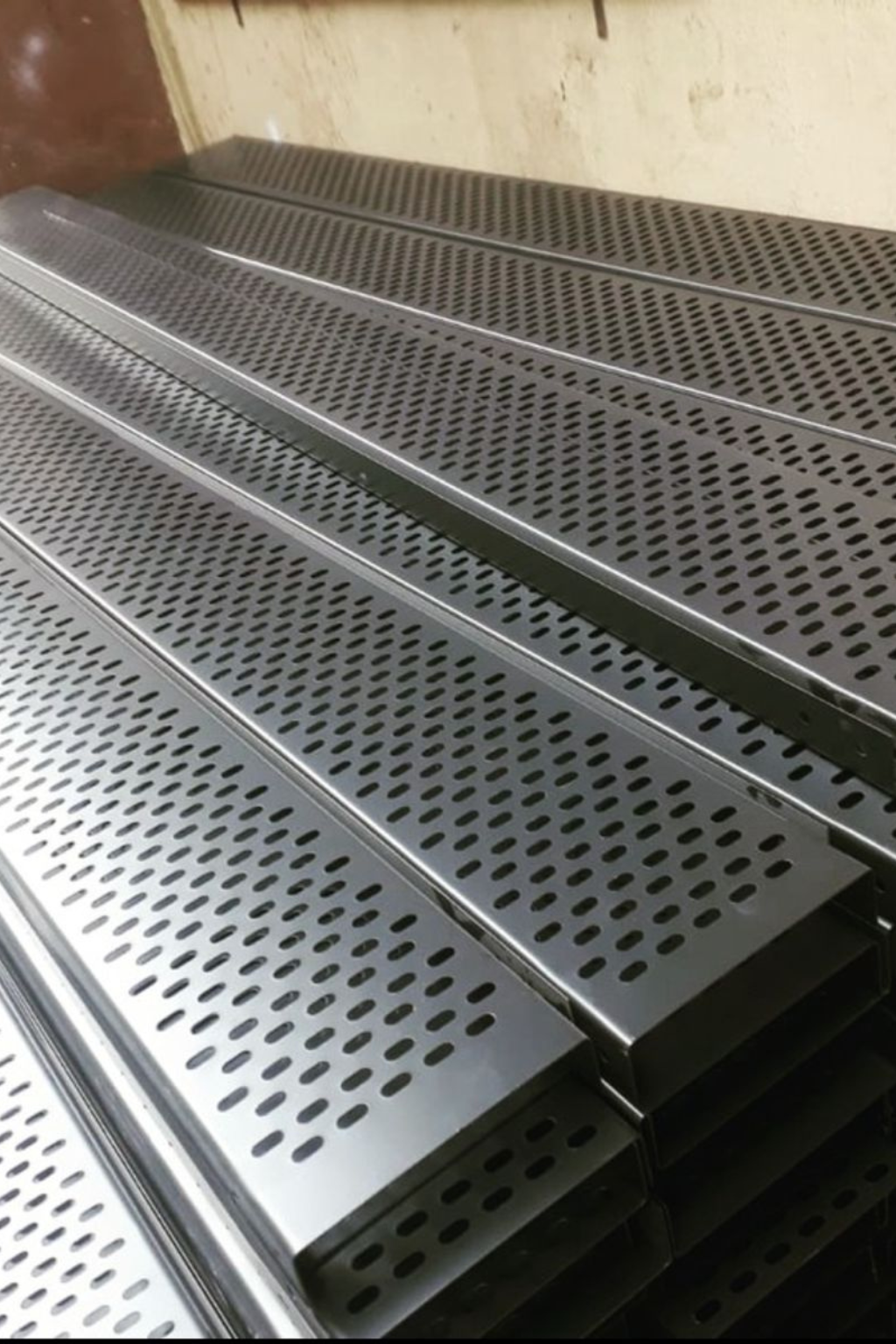 Hot Dip Galvanized Perforated Cable Trays stacked for industrial cable management – corrosion-resistant GI perforated trays by Superfab Industries Pvt. Ltd.